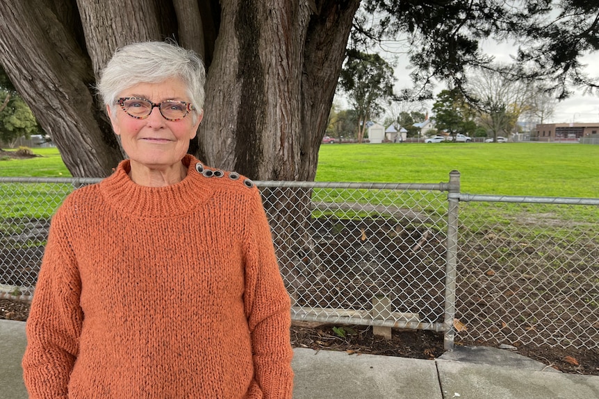 Inge Mitchell stands in front of a small wire fence and tree in Yarragon
