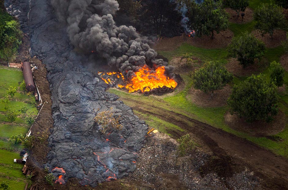 Lava sets fire to a stack of tyres.