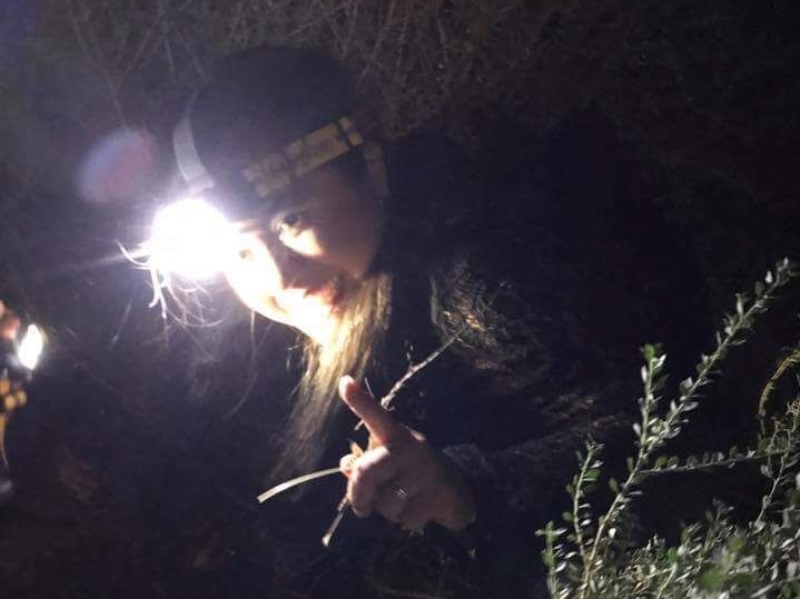 A photo of Apple Coombe catching locusts at night.