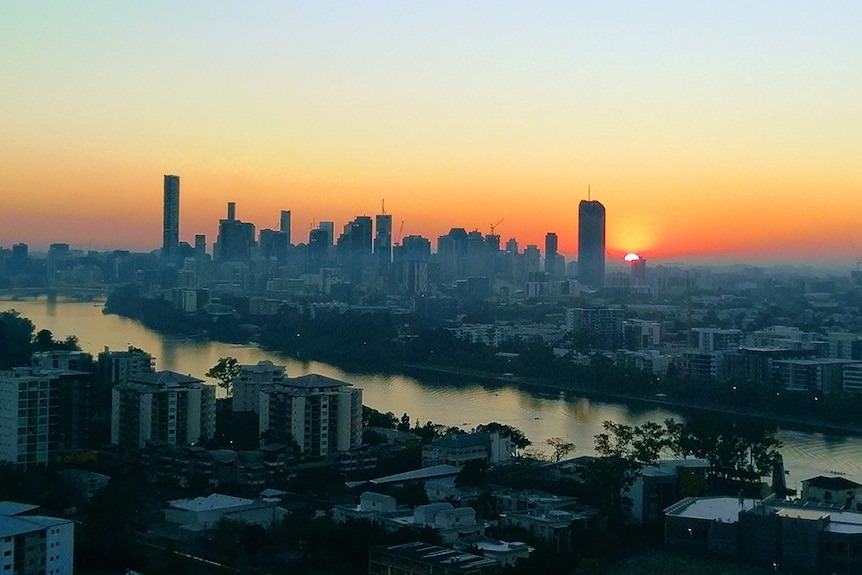 A red and orange sunrise over Brisbane.