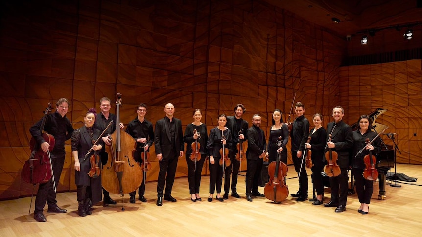 Omega Ensemble poses onstage at the Melbourne Recital Centre's Elisabeth Murdoch Hall with guest violinist Thomas Gould.