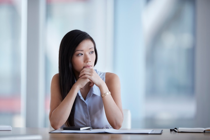 Pensive young professional woman looking into the distance