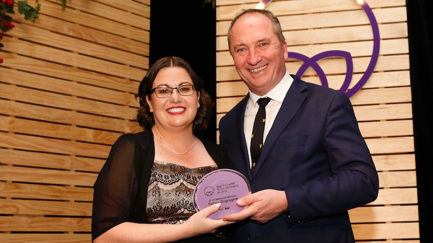 Tanya Dupagne poses with Deputy Prime Minister Barnaby Joyce after receiving her award.