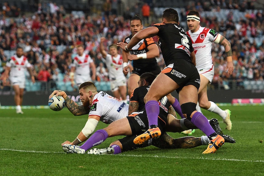 Dragons full-back Josh Dugan scores against the Tigers