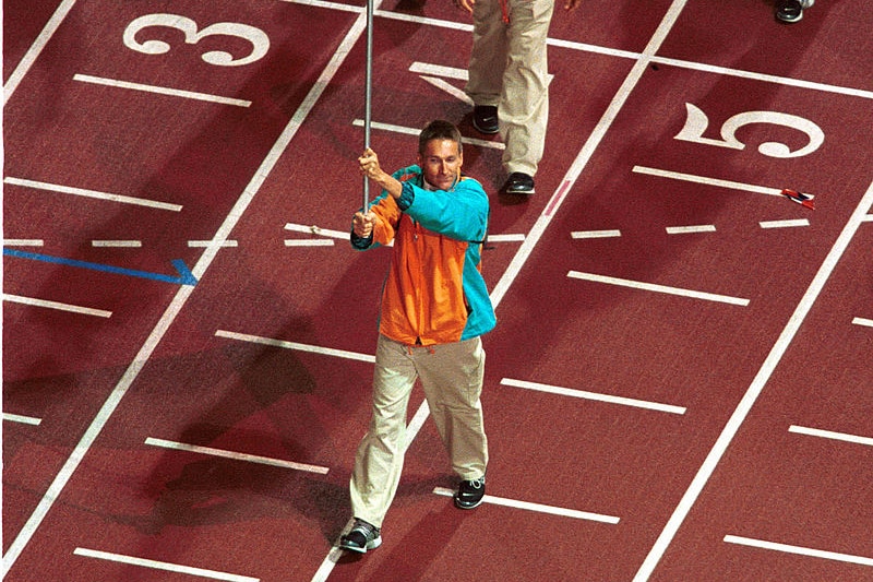 Paralympian Brendan Burkett holds the Australian flag at the Sydney 2000 Paralympic Opening Ceremony. Ausnew Home Care, NDIS registered provider, My Aged Care