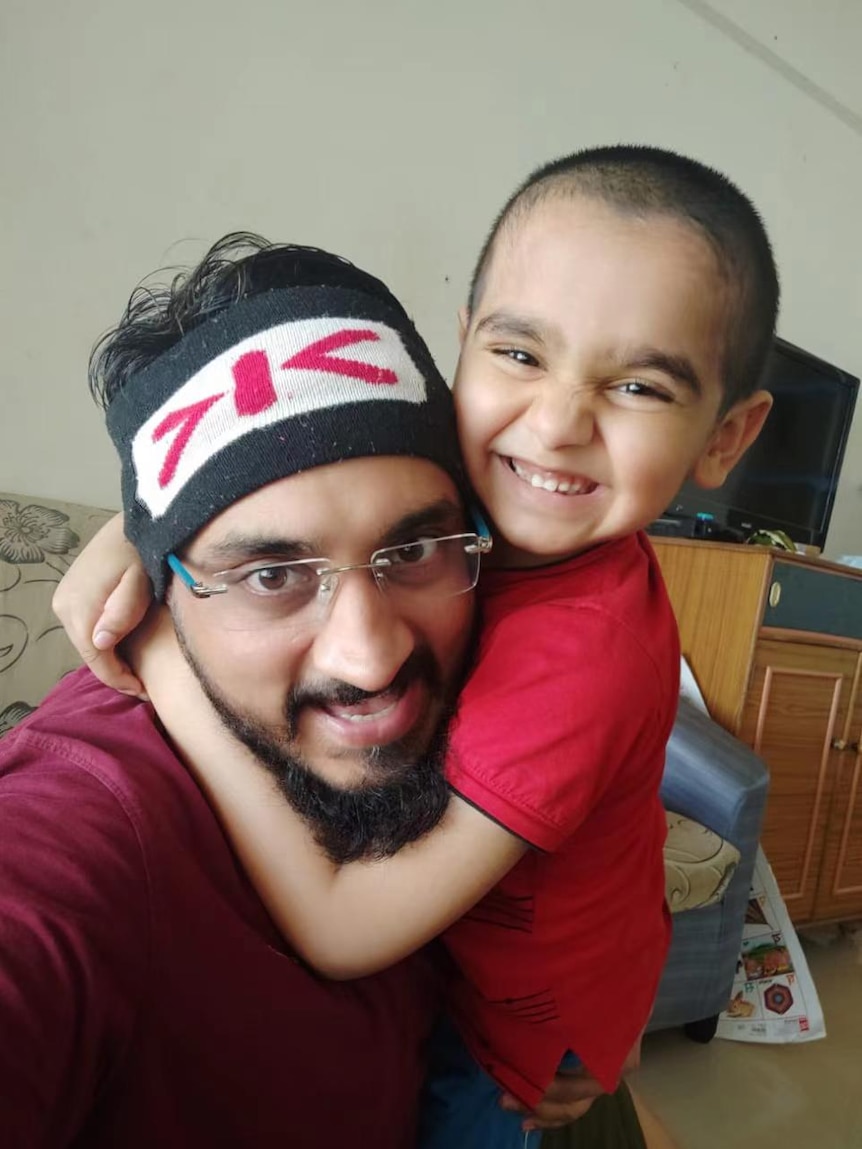 Virendrasinha Bhosale's son Vishwatej hugs him around the neck and smiles in this photo taken after he got home.