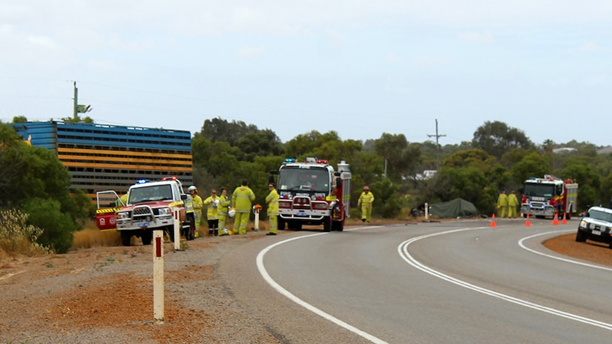 Fire trucks near a stretch of the North West Highway where a cattle truck hit a car, claiming the life of a woman.