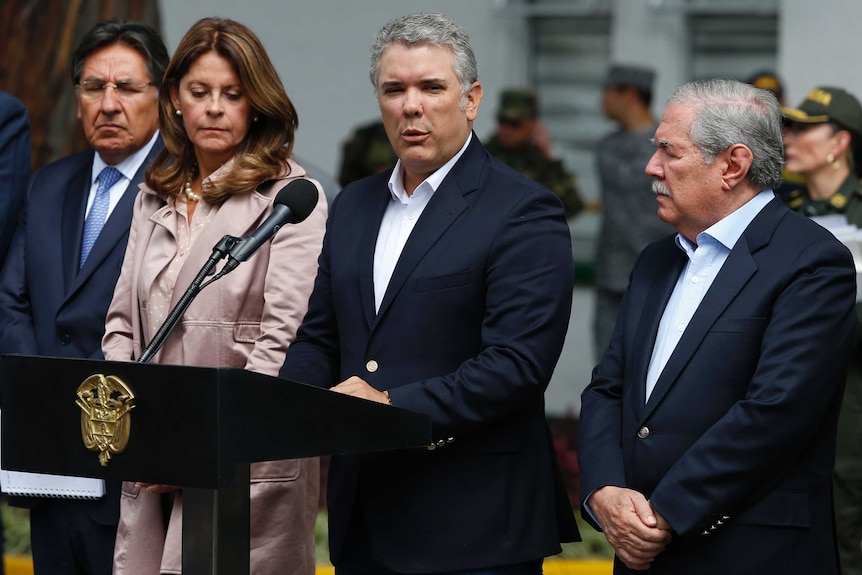 President Ivan Duque is seen giving a statement inside the police academy.