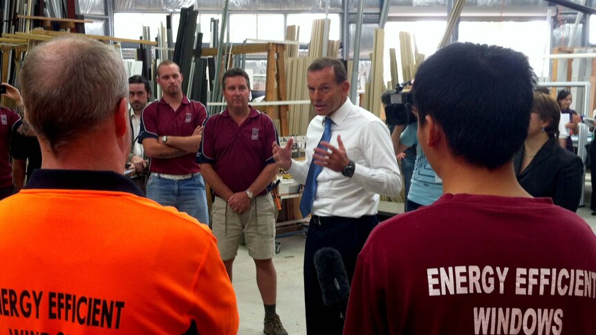 Tony Abbott speaks to workers at a window factory