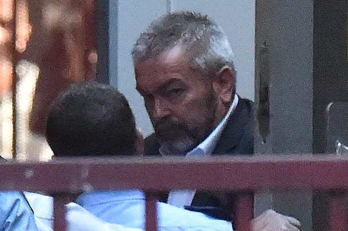 Borce Ristevski is led into court to be sentenced.