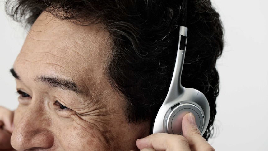 A man listens to music through his headphones.