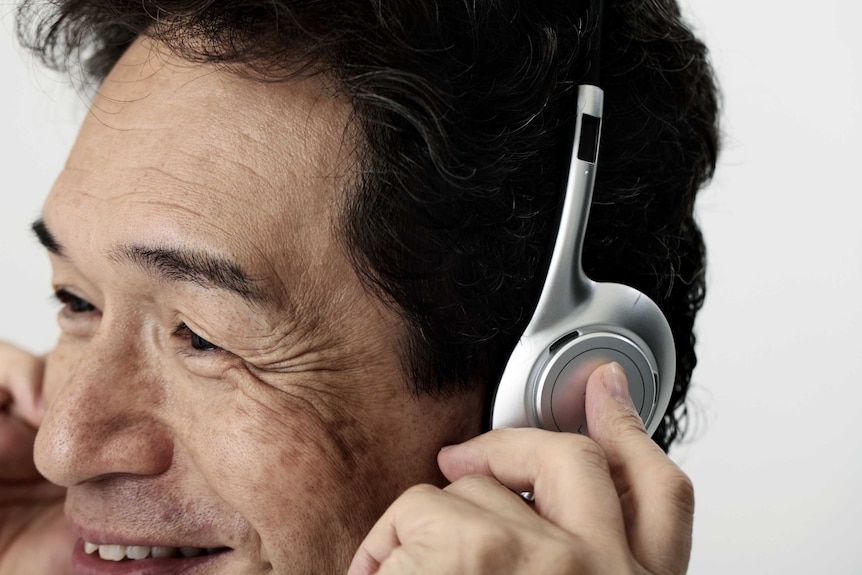 A man listens to music through his headphones.