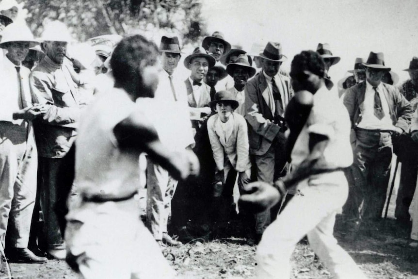 NTAS, Historical Society of the Northern Territory, NTAS 1854, Item 2676 - tow Aboriginal men wearing boxing gloves with crowd.