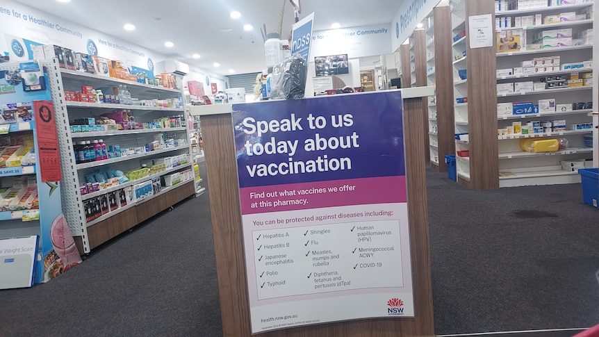 A sign in a pharmacy that says "Speak to us today about vaccinations".