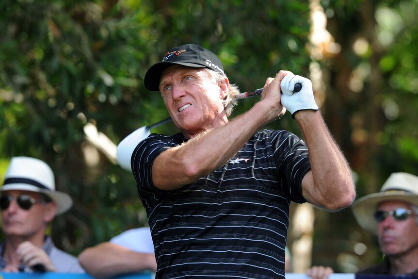 Australian golfer Greg Norman looks on after playing a shot.