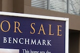 For sale sign in front of a house