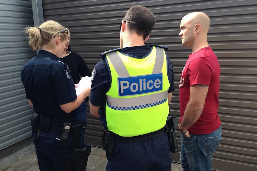 Members of Victoria Police talking to Paul and Justine Cubbin about the dispute