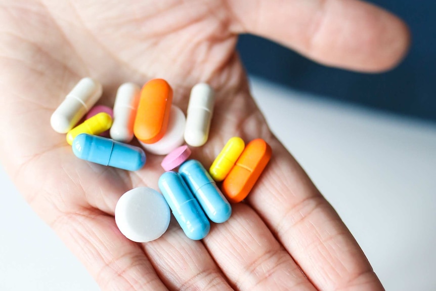 Medicine on a person's palm.