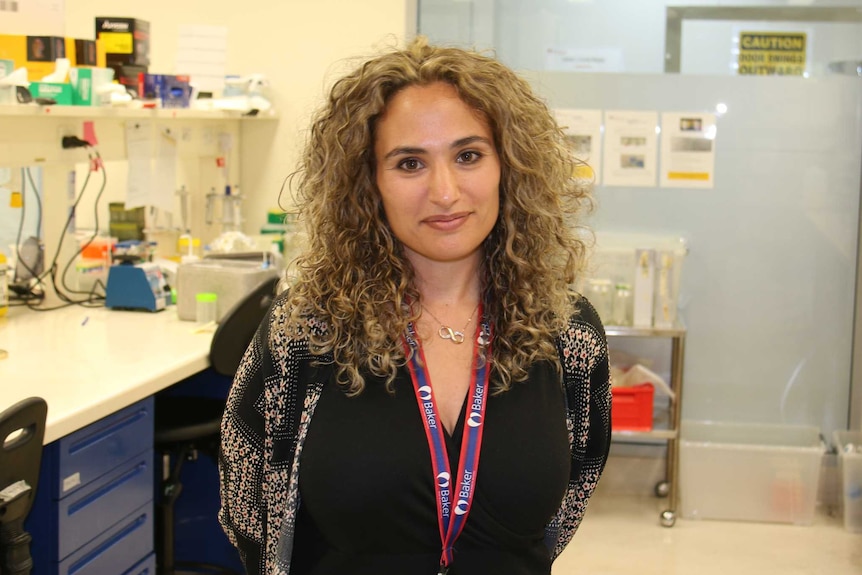 Stephanie Yiallourou stands in a laboratory.