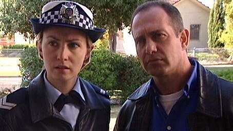 A promotion picture of actress Lisa McCune and Martin Sacks working on the show Blue Heelers.