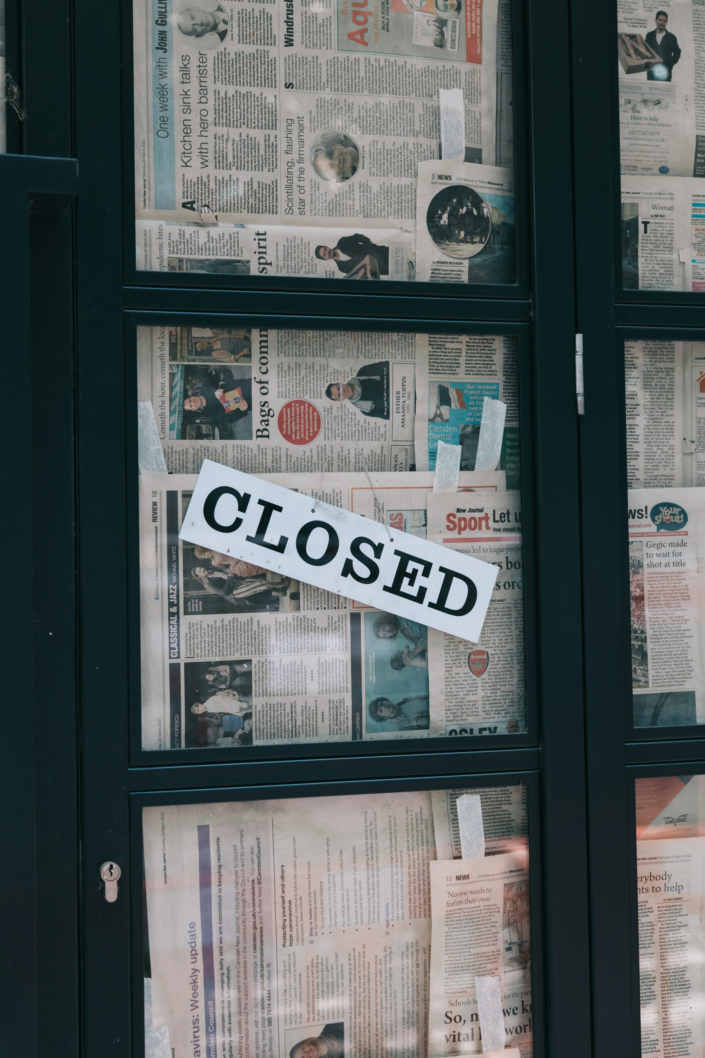 A handwritten sign on a glass door reads 'closed until further notice.'
