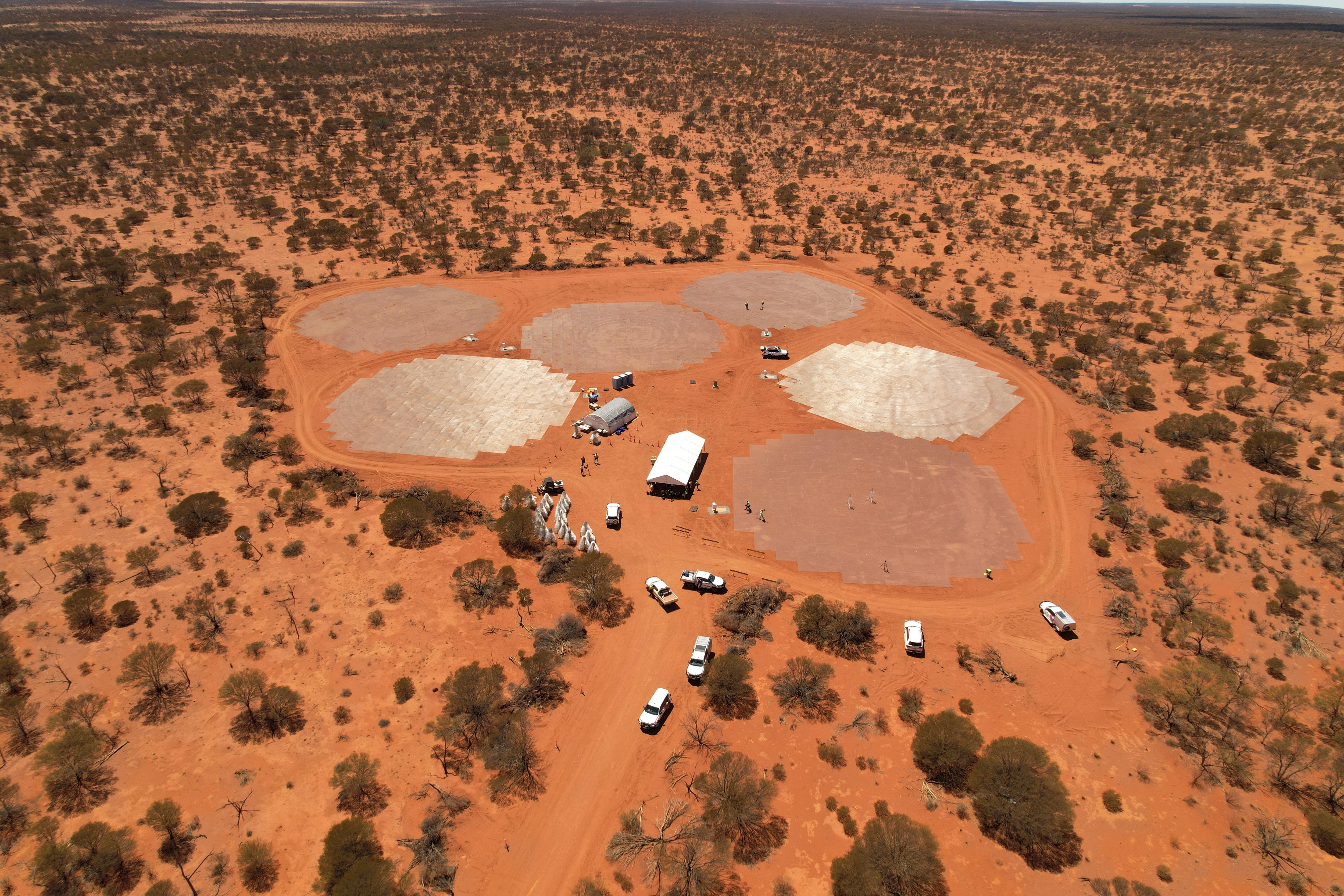 An aerial drone shot of a facility being built in the WA outback, with lots of red dirt surrounding. 