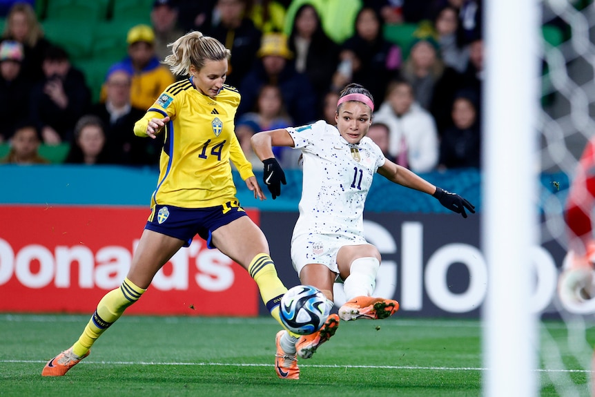 USA's Sophia Smith kicks a ball under pressure from Nathalie Björn of Sweden at the FIFA Women's World Cup.