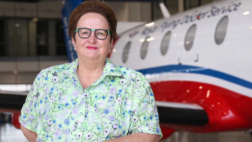 Former senator Amanda Vanstone stands in front of an RFDS plane.