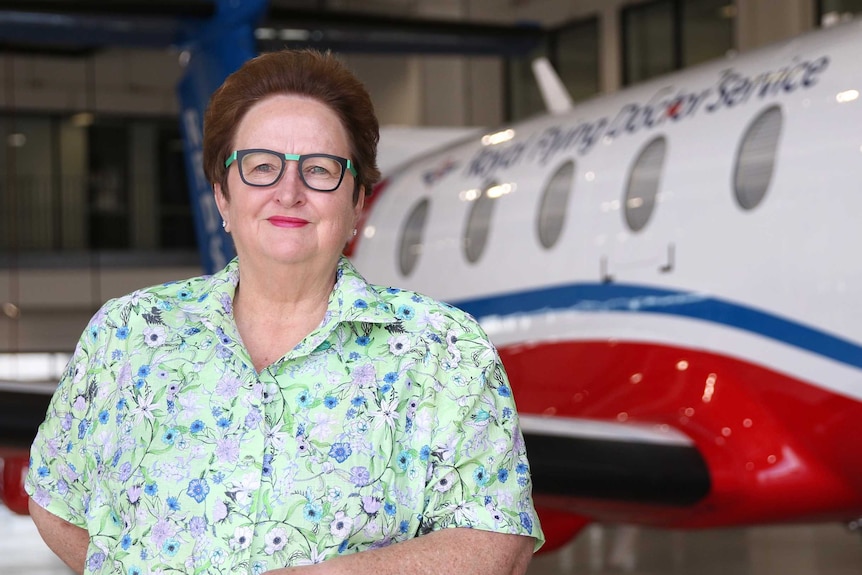 Former senator Amanda Vanstone stands in front of an RFDS plane.