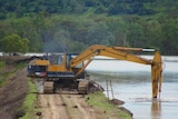 Farmers try to improve levee banks to protect their cotton crops earlier this year, ahead of floodwaters.