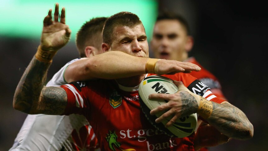 Warpped up ... Josh Dugan is hit in a high tackle