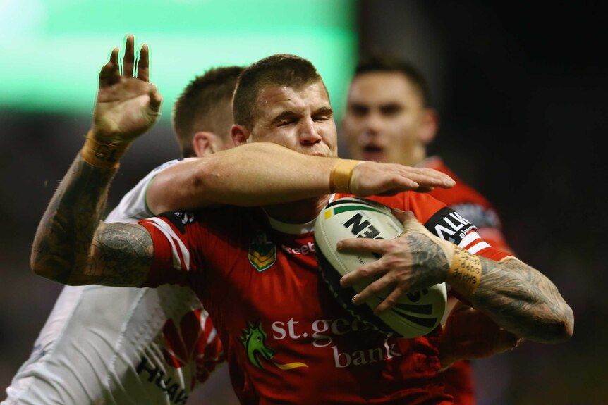 Warpped up ... Josh Dugan is hit in a high tackle