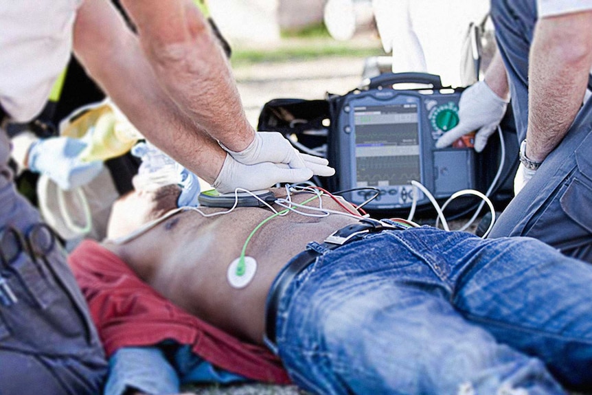 Paramedics use a defibrillator to revive a patient.
