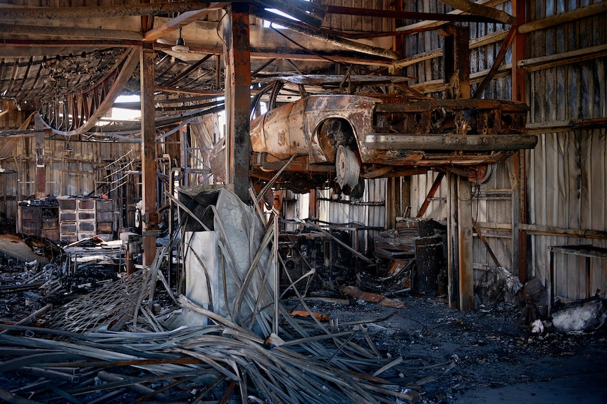 Charred remains of Kerry Kyriacou's joinery business after a fire gutted the building in the industrial area of Woolner.