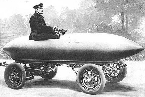 A black and white illustration of a man in a hat perched in a torpedo-shaped car