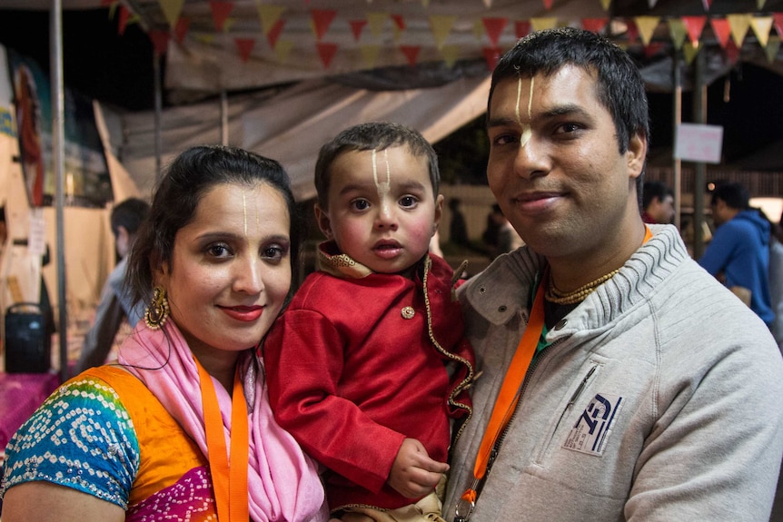 A young family at the Krishna birthday celebration.