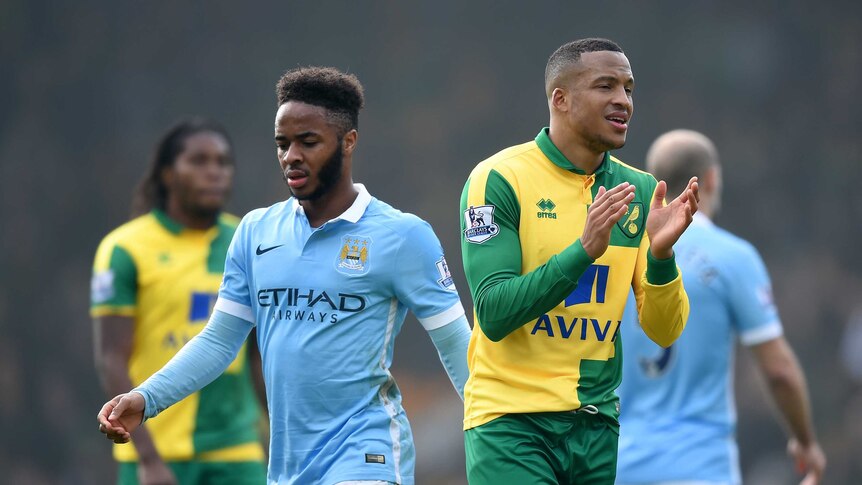 Manchester City's Raheem Sterling looks on as Norwich's Martin Olsson applauds