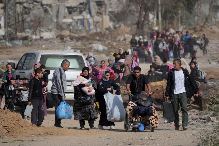 Displaced families from Gaza walking on the road. 