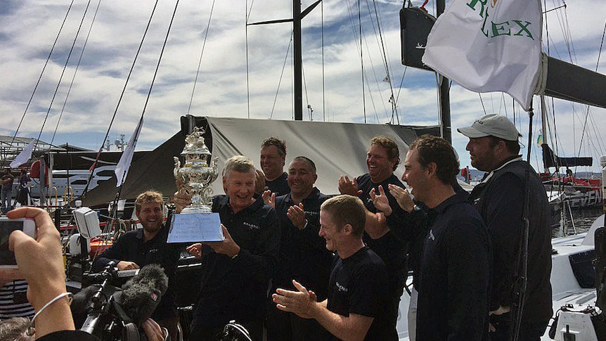 Balance owner and skipper Paul Clitheroe holds the handicap winner's cup.