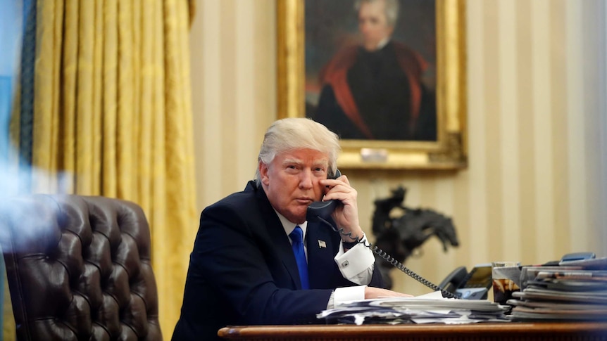 President Donald Trump speaks on the phone