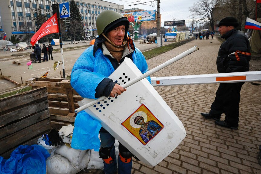 Pro-Russian protester shows his gear