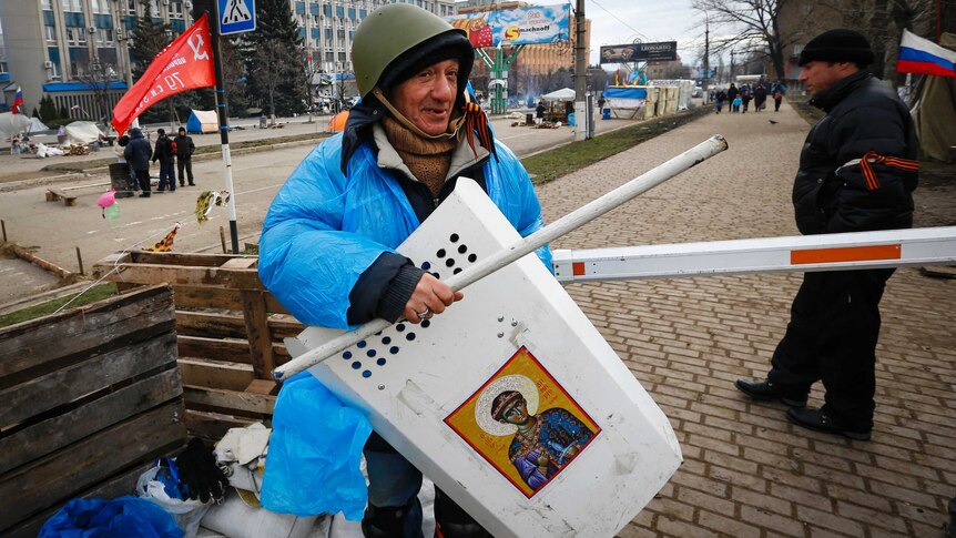 Pro-Russian protester shows his gear