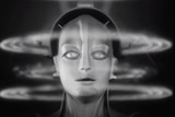 A still image from the original film shows a robot woman with waves over her head in black and white.