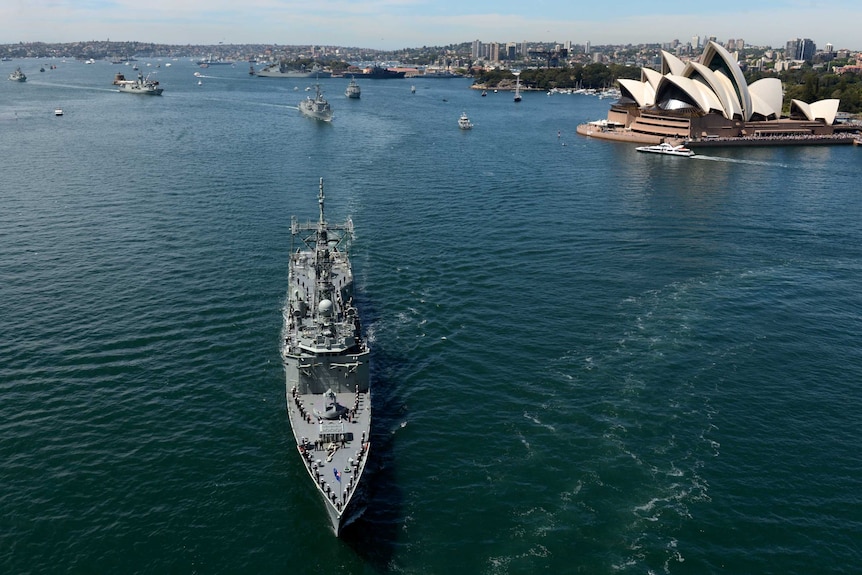 The Royal Australian Navy fleet makes its way along Sydney Harbour for the International Fleet Review.
