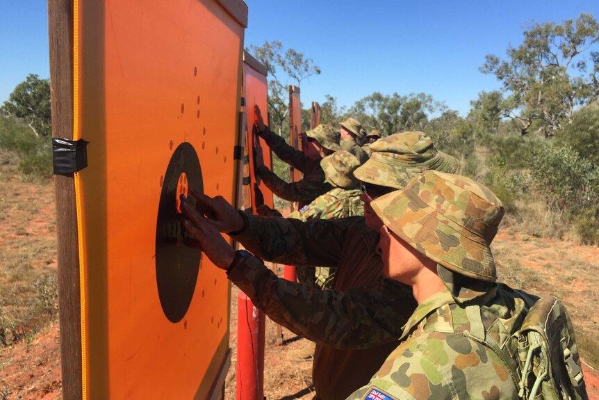 Norforce recruits master rifle skills to protect themselves from crocodiles common in remote Australia.