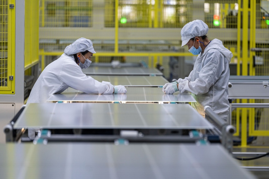 Workers produce solar photovoltaic modules