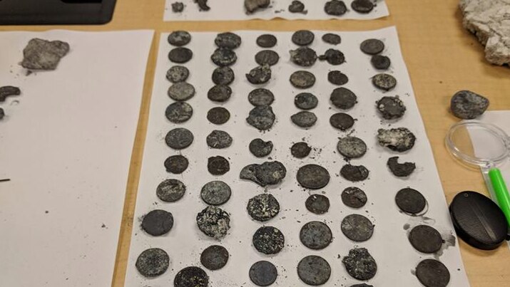 Coins on display after Ear Spring eruption