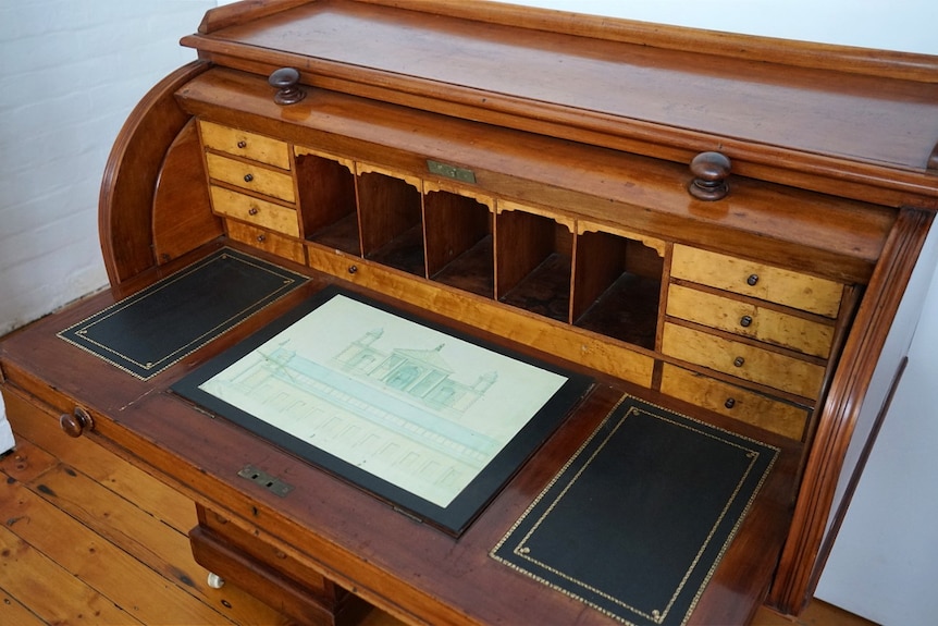 An old, vintage brown draftsman's desk.