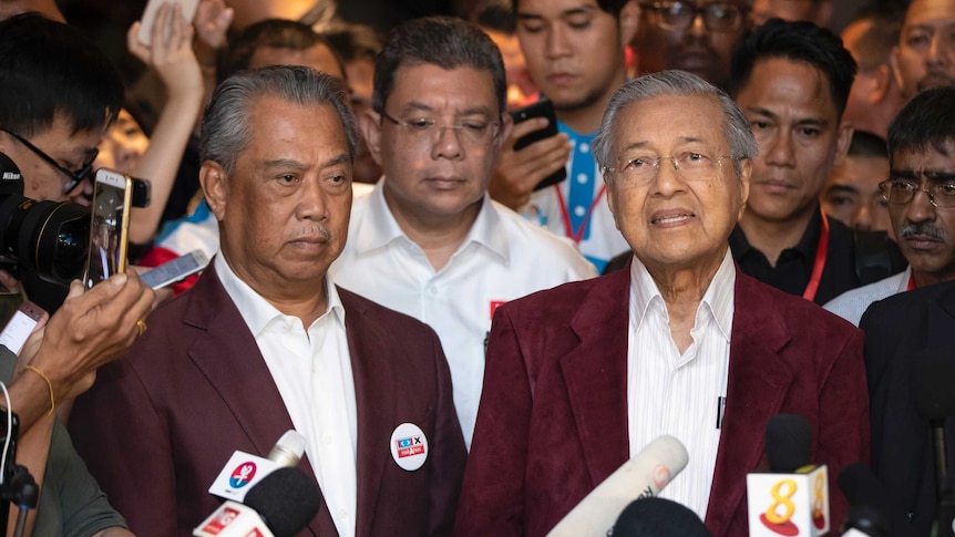 Mahathir Mohamad speaks at a press conference alongside Muhyiddin Yassin.