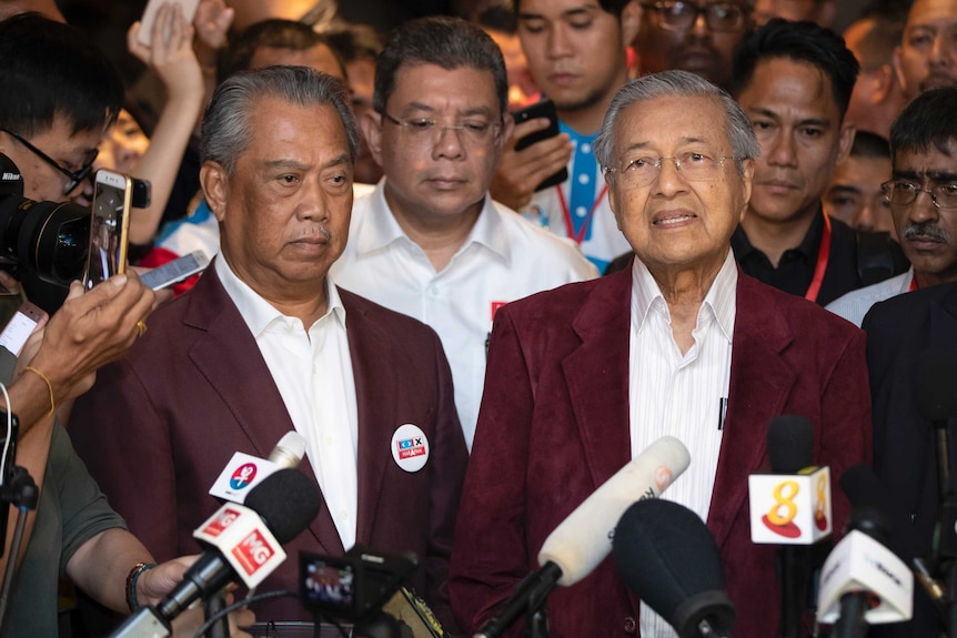 Mahathir Mohamad speaks at a press conference alongside Muhyiddin Yassin.